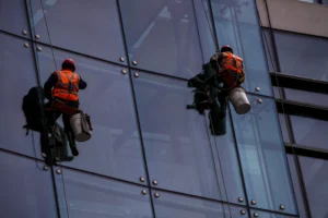 Window cleaners scaling skyscraper